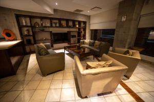a large living room with couches and a table at Hotel Colonial Hermosillo in Hermosillo