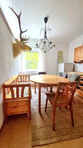 a dining room with a table and a deer head on the wall at Best Time In Graz in Graz