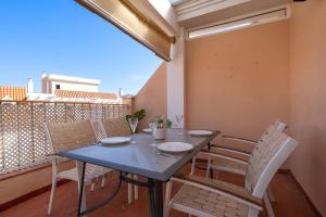 a blue table and chairs on a balcony at 28 Rooftop apartment close to the beach Sabinillas in San Luis de Sabinillas