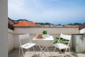 d'une table blanche et de deux chaises sur un balcon. dans l'établissement APPARTAMENTO LA MANSARDINA, à Sestri Levante