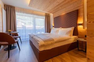 Postel nebo postele na pokoji v ubytování Hotel Alpi