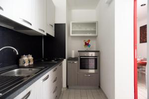 a small kitchen with a sink and a stove at Fabio's BnB in Milan
