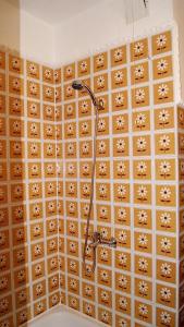 a shower in a bathroom with brown tiles at Mieszkanie z kuchnią i łazienką in Augustów