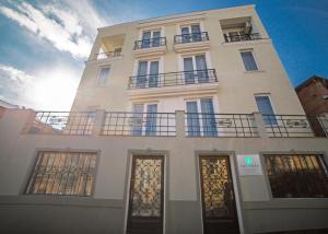 a white building with two balconies on top of it at Hotel Kera in Tbilisi City