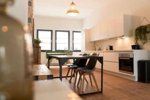 een keuken met een tafel en stoelen in een kamer bij Hippie chic ! in Bergen