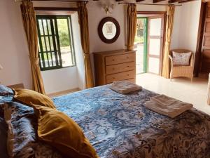 una camera da letto con un grande letto con due cuscini sopra di Spacious characterful villa with spectacular views in quiet rural setting. a Breña Alta