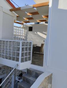 a staircase leading to a room with a table at VILLA PENELOPE in Tourlotí