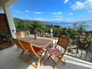 a table and chairs on a balcony with a view at Apartments Gajeta in Povile