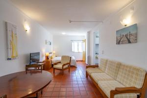 a living room with a couch and a table at Apartamentos Atlantico by Umbral in Vila Nova de Milfontes