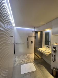 a bathroom with a shower and a sink at Nature & Design in Bonifacio
