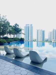 three white chairs sitting on top of a body of water at Near Gleaneagles & Legoland-2RB WarmKitten Max7pax-COWAY WaterDispenser in Nusajaya