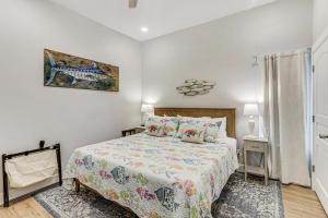 a bedroom with a bed and a picture on the wall at Beachin' Good Time in Port Aransas +49 photos