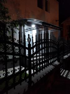 a black fence in front of a building at night at Apartment & Studio Isidora in Novi Sad