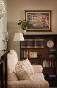 a living room with a couch and a book shelf with books at Palace suite apartment by Toledo AP in Toledo