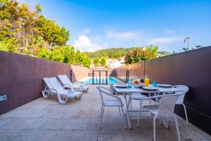 un patio con mesa, sillas y piscina en Portugal Active Moledo Beach House, en Moledo