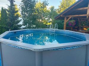 a swimming pool in the backyard of a house at Słowikowy Zakątek in Meszna