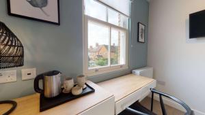 a kitchen with a counter and a window at The Oxford Lodge in Oxford