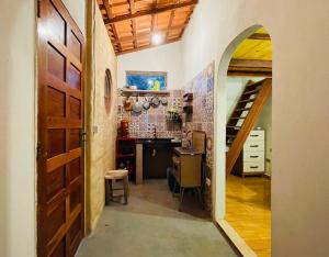 a hallway with an archway leading into a kitchen with a desk at Hospedagem Sabor Da Trilha in Vale do Capao