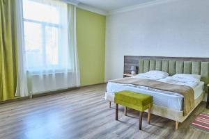 a bedroom with a bed and a large window at 21 Rooms Hotel in Gyumri