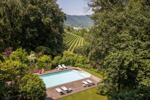 an overhead view of a swimming pool in a garden at L'Albereta Relais & Chateaux in Erbusco