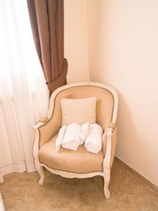 a chair with towels on it with a pillow at Monti 66 Hotel in Rome