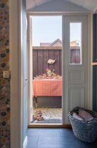 a door leading into a dining room with a table at 1700-talshus i två plan med egen innergård i Visby innerstad in Visby