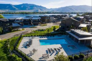 an aerial view of a resort with a lake and mountains at Luxury Ski Home 5 min from SnowBasin, 50' from Pineview Lake in Huntsville