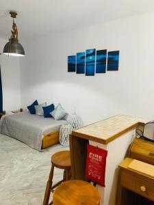 a bedroom with a bed and a table and chairs at Limni No 2 self catering apartment in Posidhonía