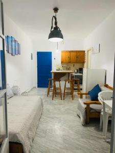 a living room with a table and a kitchen at Limni No 2 self catering apartment in Posidhonía