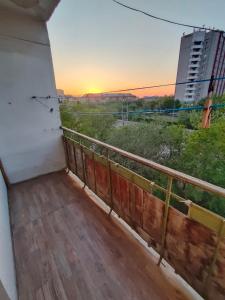 a balcony with a view of the sunset at Glinki 33 Apartments in Semey