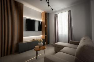 a living room with a couch and a table at Aggire Zante Luxury Residence in Zakynthos Town