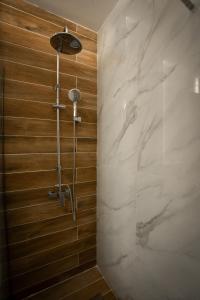 a bathroom with a shower with white marble at Aggire Zante Luxury Residence in Zakynthos