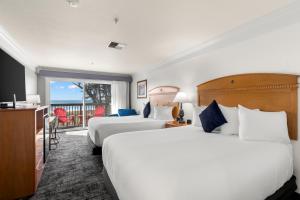 a hotel room with two beds and a balcony at Beachcomber Motel in Fort Bragg