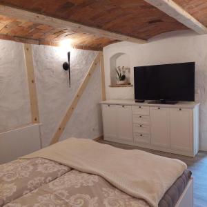 a bedroom with a bed and a flat screen tv at Spreewald Ruhe in Radensdorf