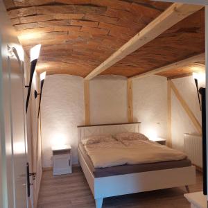 a bedroom with a bed and two night stands at Spreewälder Sorbenstübchen in Radensdorf