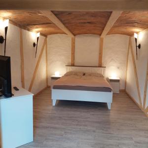 a bedroom with a bed in a room with wooden ceilings at Spreewald Ruhe in Radensdorf