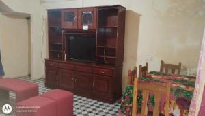 a living room with a large entertainment center with a television at Flia brover (Lalo) in Puerto Iguazú