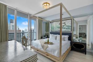 a bedroom with a canopy bed with a view of the city at Special Offer at Icon Brickell with Ocean view in Miami