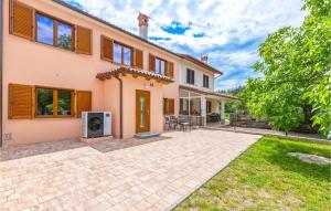 an exterior view of a house with a patio at 2 Bedroom Awesome Home In Podgorje in Podgorje