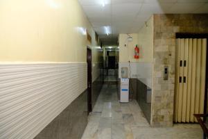 a hallway of a building with a refrigerator in it at Aum Karthikeya Residency in Chennai