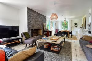 a living room with a couch and a fireplace at Maison de charme à la campagne in Roupy