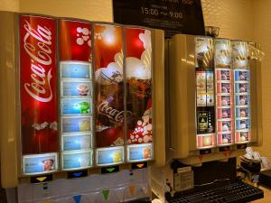 a vending machine filled with different kinds of drinks at IAM HOTEL in Osaka