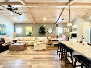 a living room with a couch and a table at SeaKing Relaxation where the waves meet the shore and time slows down in Port Aransas