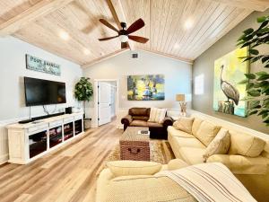 a living room with a couch and a flat screen tv at SeaKing Relaxation where the waves meet the shore and time slows down in Port Aransas