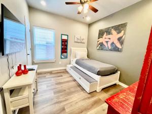 a bedroom with a bed and a ceiling fan at SeaKing Relaxation where the waves meet the shore and time slows down in Port Aransas +37 photos