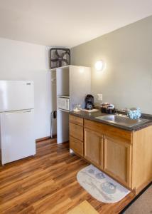 a kitchen with a sink and a refrigerator at The Pioneer Motel in Palmer