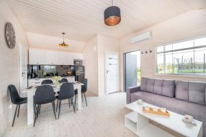 a living room with a couch and a table at Domki Hulaj Dusza in Bobolin