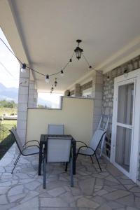 a patio with a table and chairs on a patio at Apartman Delać in Tivat