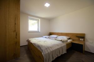 a bedroom with a large bed and a window at Holiday House Chilly in Kotlje