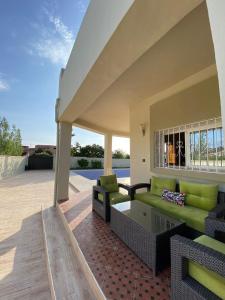 a living room with a couch and a table at Vila Haja - Beautiful Farmhouse with a Private Pool! in Imouzzer Kandar